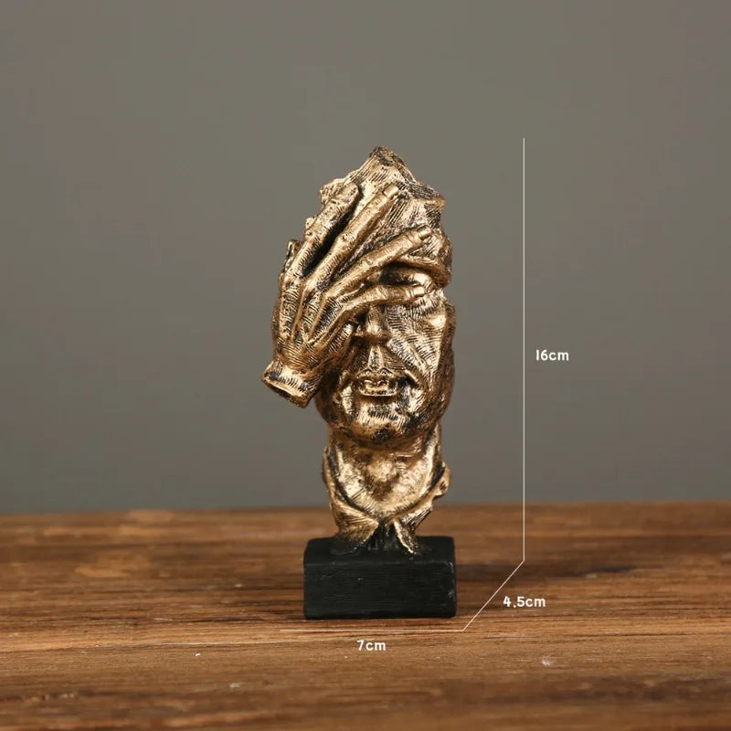 Bronze sculpture with facepalm gesture on a gray background, with the measurements: 7cm x 16cm x 4.5cm