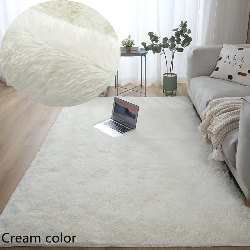 Cream-colored rug in a living room with a laptop and decor items.