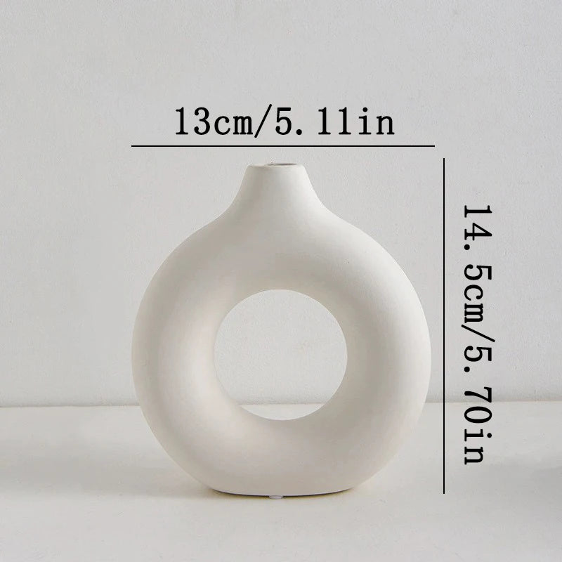 White ceramic vase with circular design on a light gray background, measurements: (D)13cm x (H)14.5cm