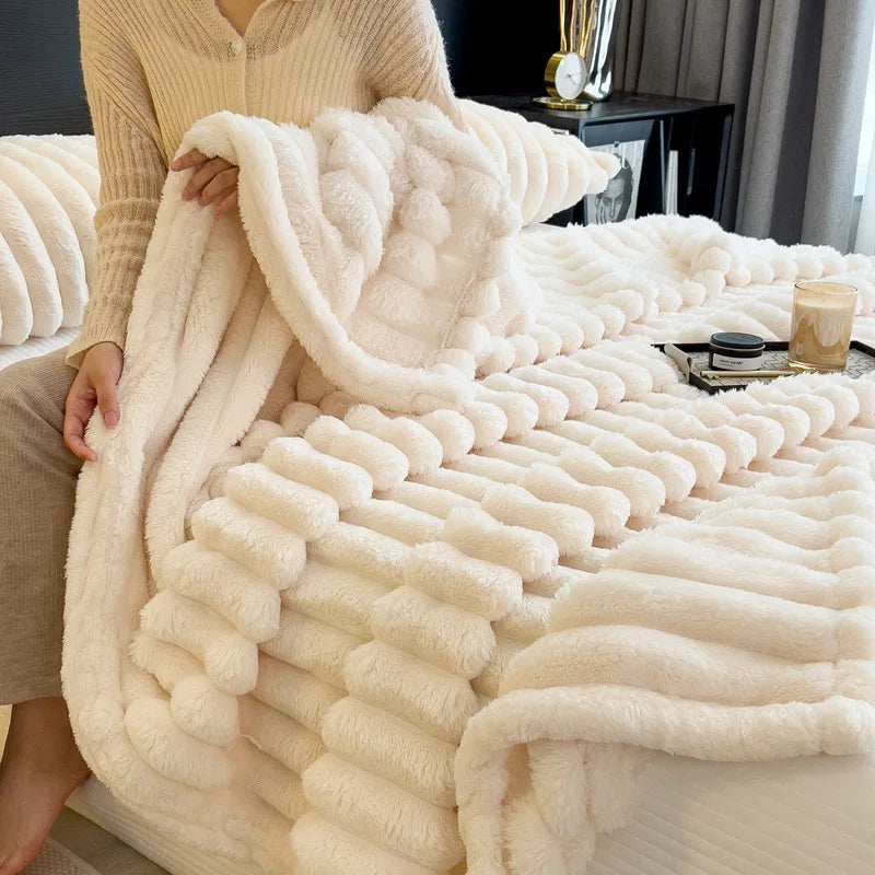 Person holding a fluffy white blanket in a cozy room.