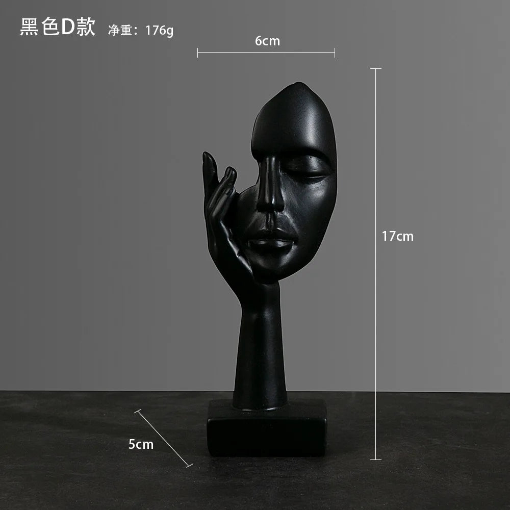 Black abstract sculpture of a face and hand on a dark surface with: 5cm x 17cm x 6cm