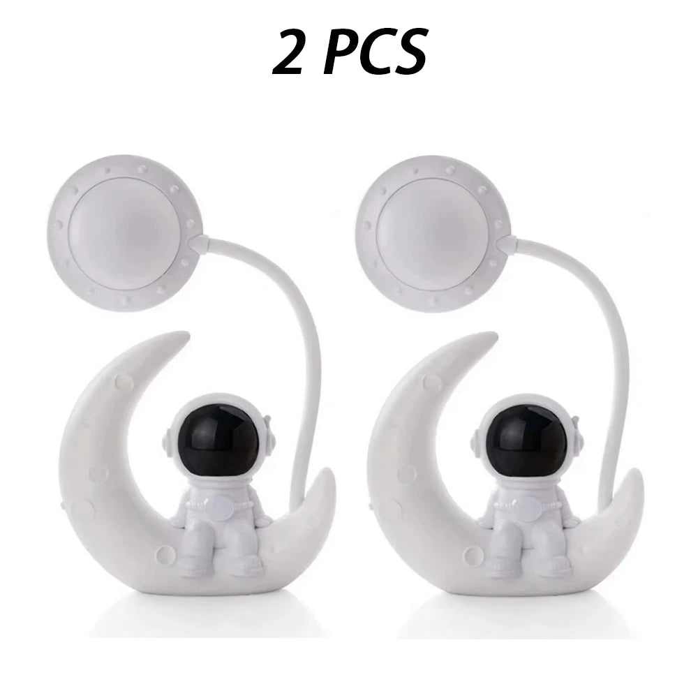 Two white moon-shaped figures with black astronaut heads on a white background, labeled '2 PCS'.