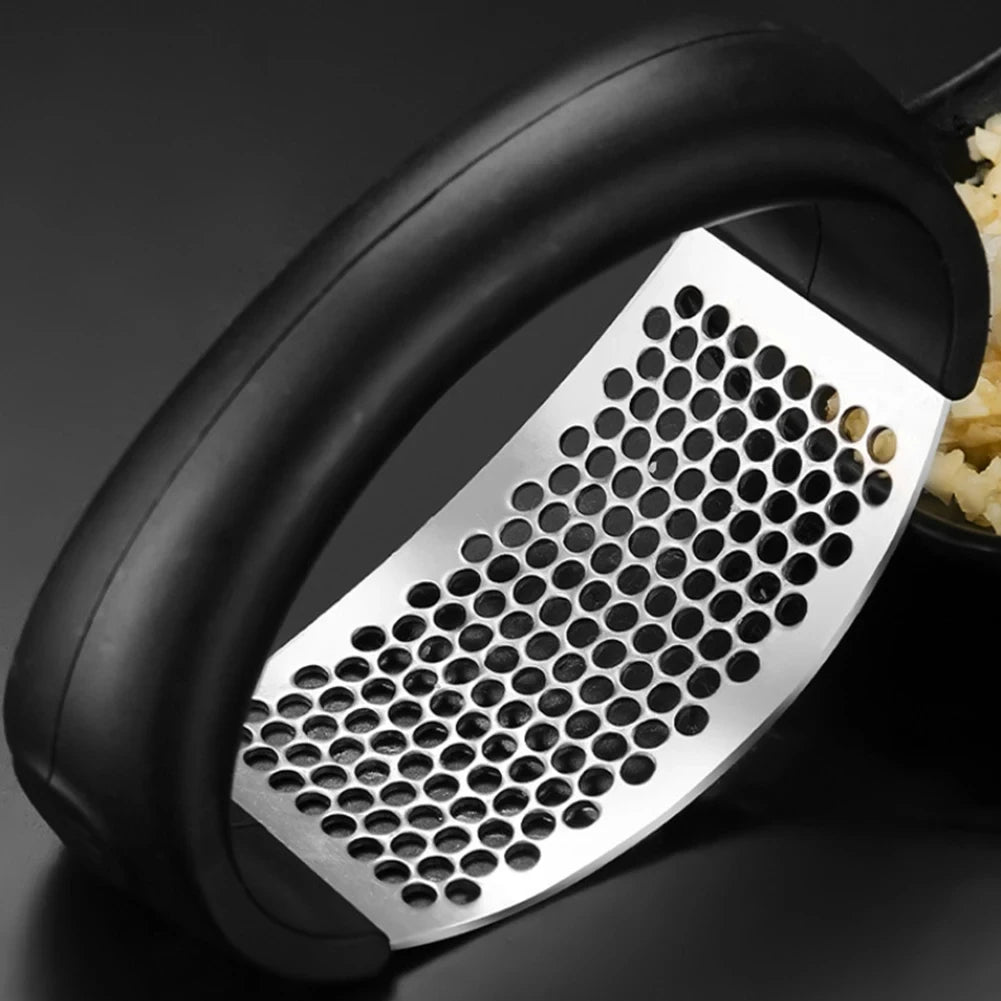 Black and silver grater with a bowl of grated food on a dark background