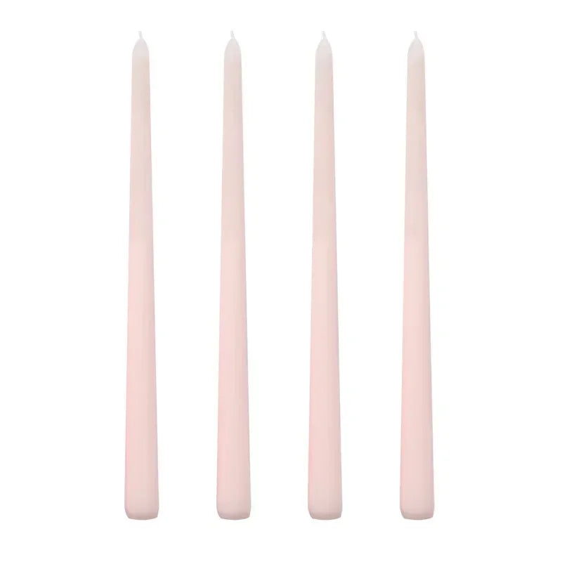 Set of four pink candles on a white background