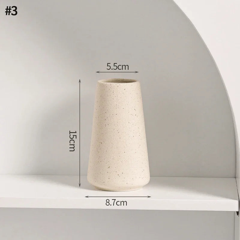 White ceramic vase with dimensions: 8.7cm diameter base, 5.5cm diameter hole, 15cm height