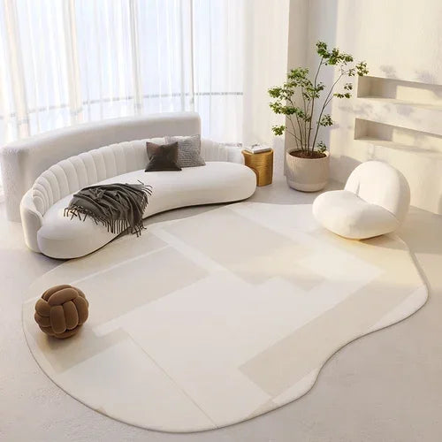 Modern living room with a white sofa, rug, and decorative items.