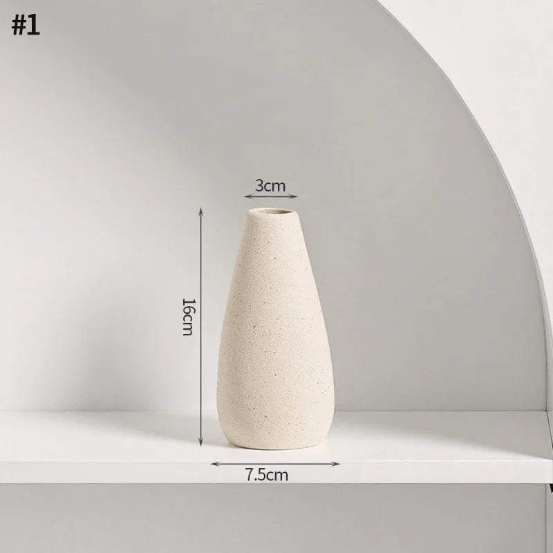 White ceramic vase with dimensions: 7.5cm diameter base, 3cm diameter hole, 16cm height