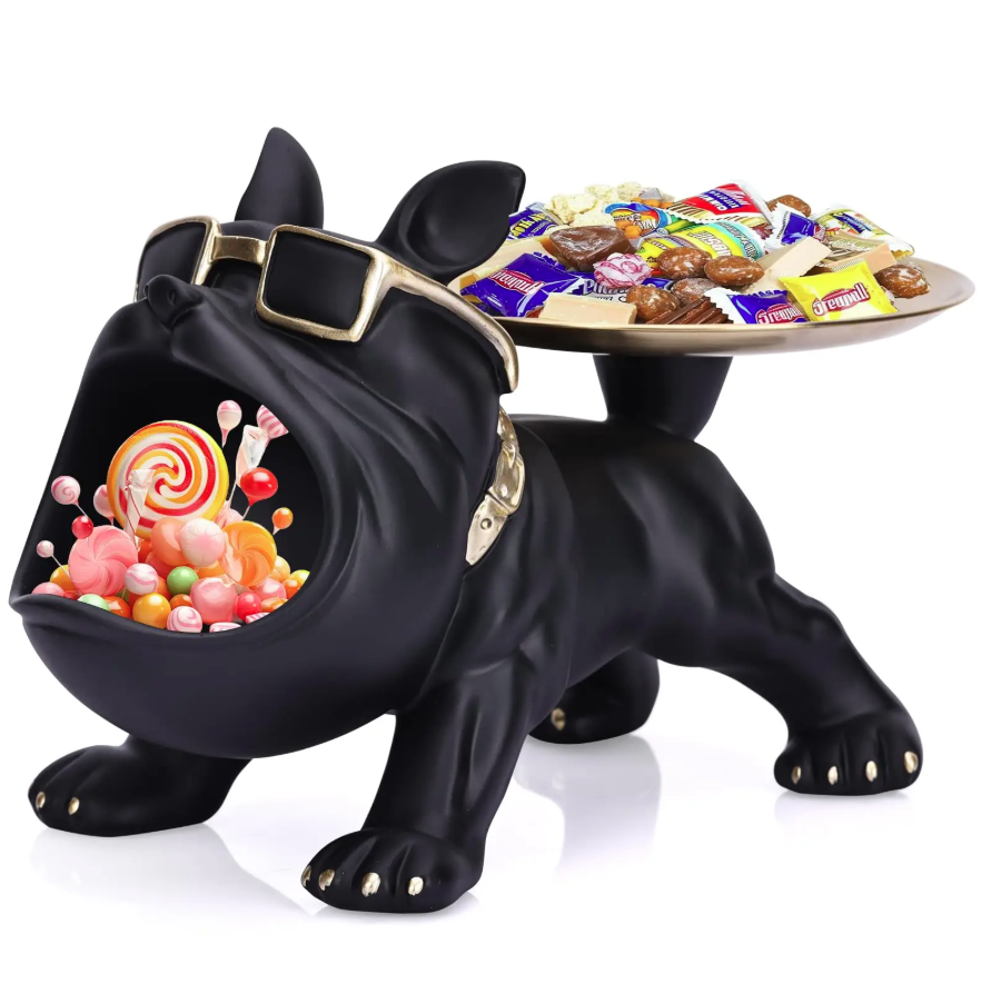 Black bulldog-shaped candy dish with a tray of candies on a white background