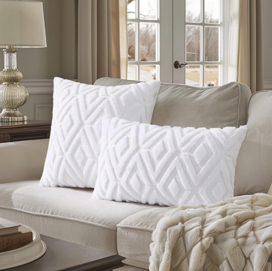 White textured pillows on a beige sofa in a living room setting.