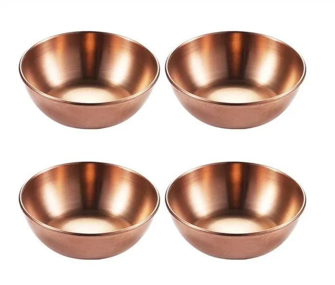 Four copper bowls on a white background