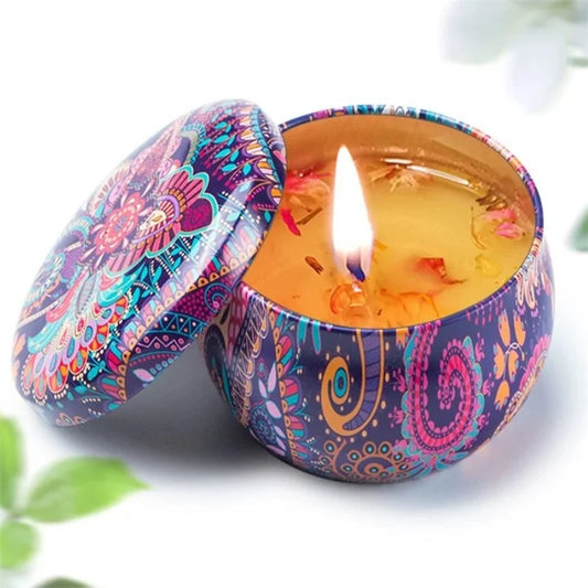 Decorative candle in a colorful tin with a flame on a white background