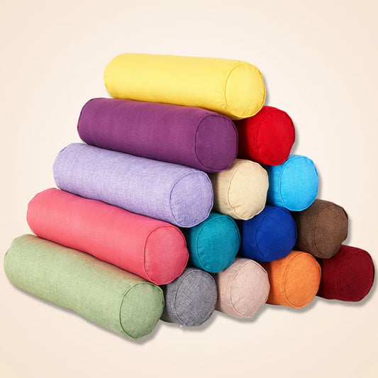 Stack of colorful cylindrical pillows on a beige background