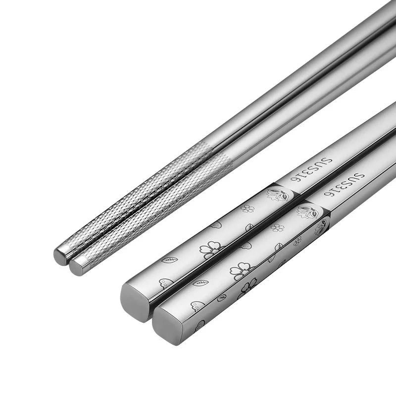 Pair of silver chopsticks with butterfly design on a white background