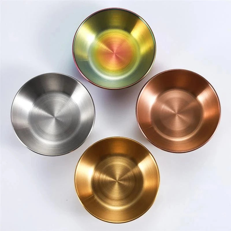 Four metallic bowls in silver, gold, bronze, and  iridescent on a white background