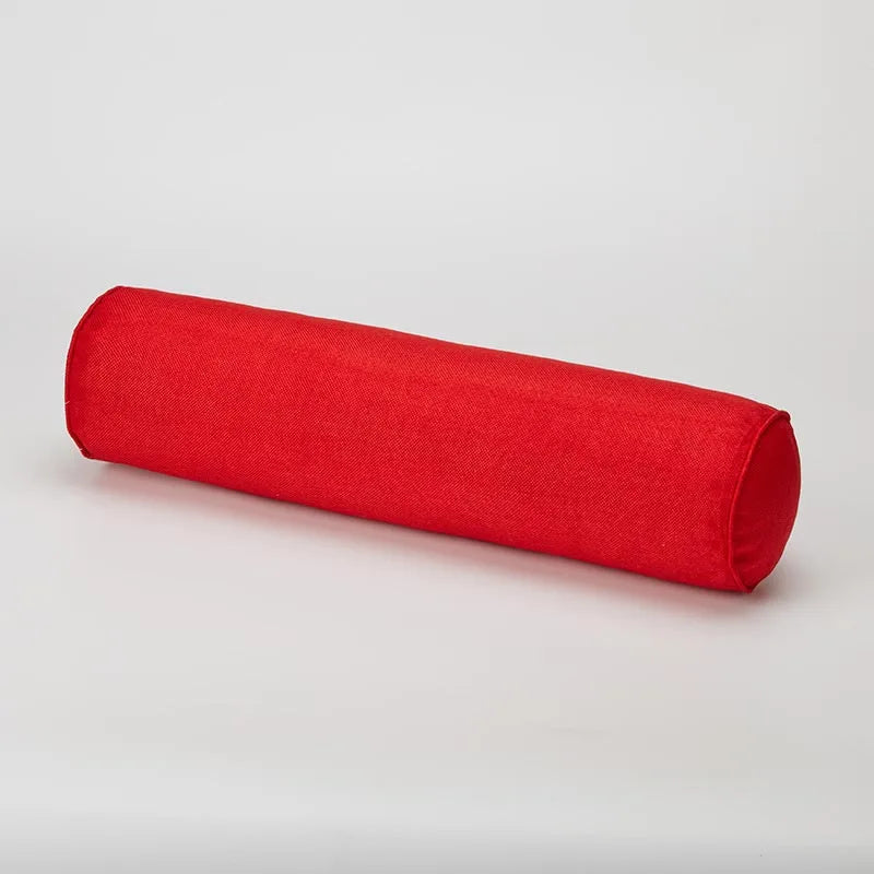 Red cylindrical pillow on a light gray background