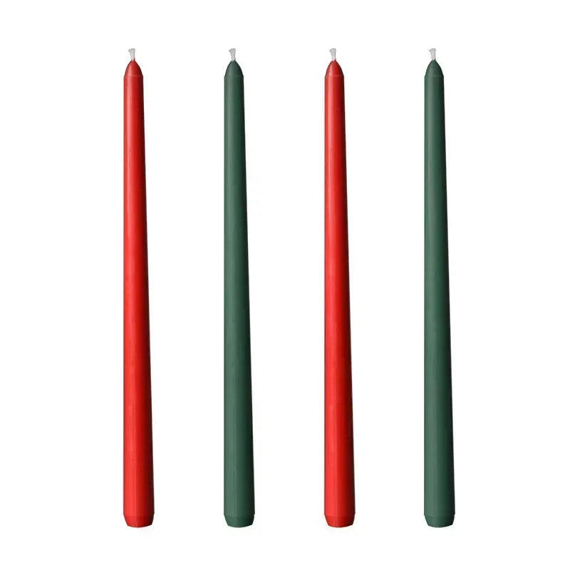 Two red and two green candles on a white background