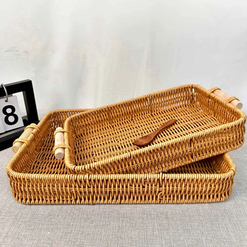 Set of woven trays with a wooden spoon on a light gray surface.