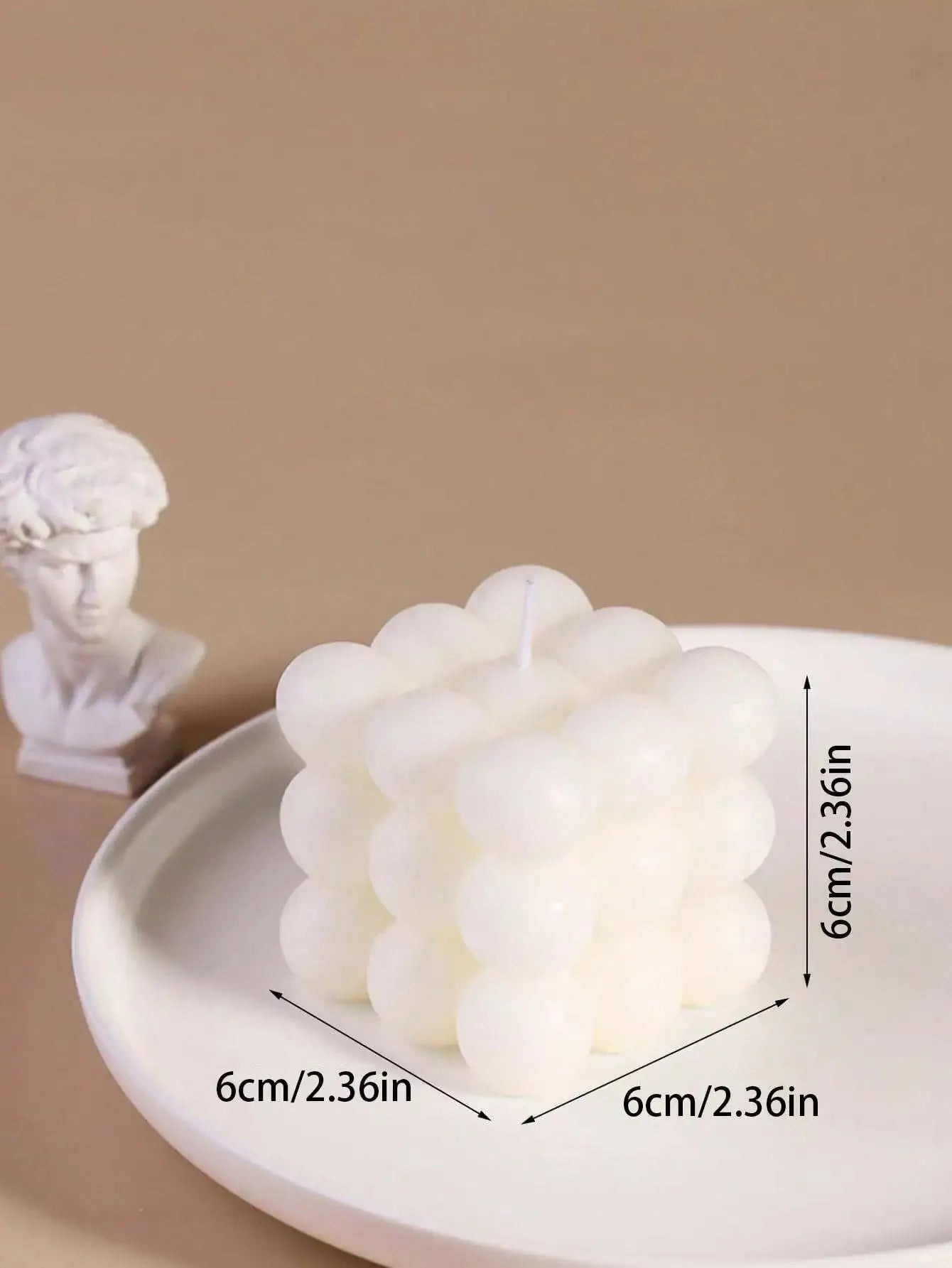 White decorative item on a beige surface with measurements: 6cm x 6cm x 6cm