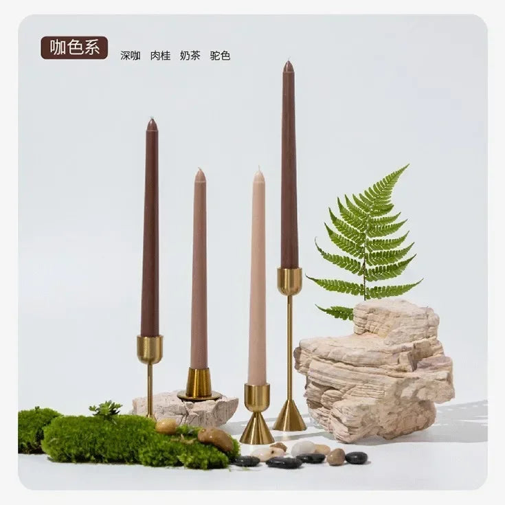 Set of brown candles with decorative elements on a light gray background