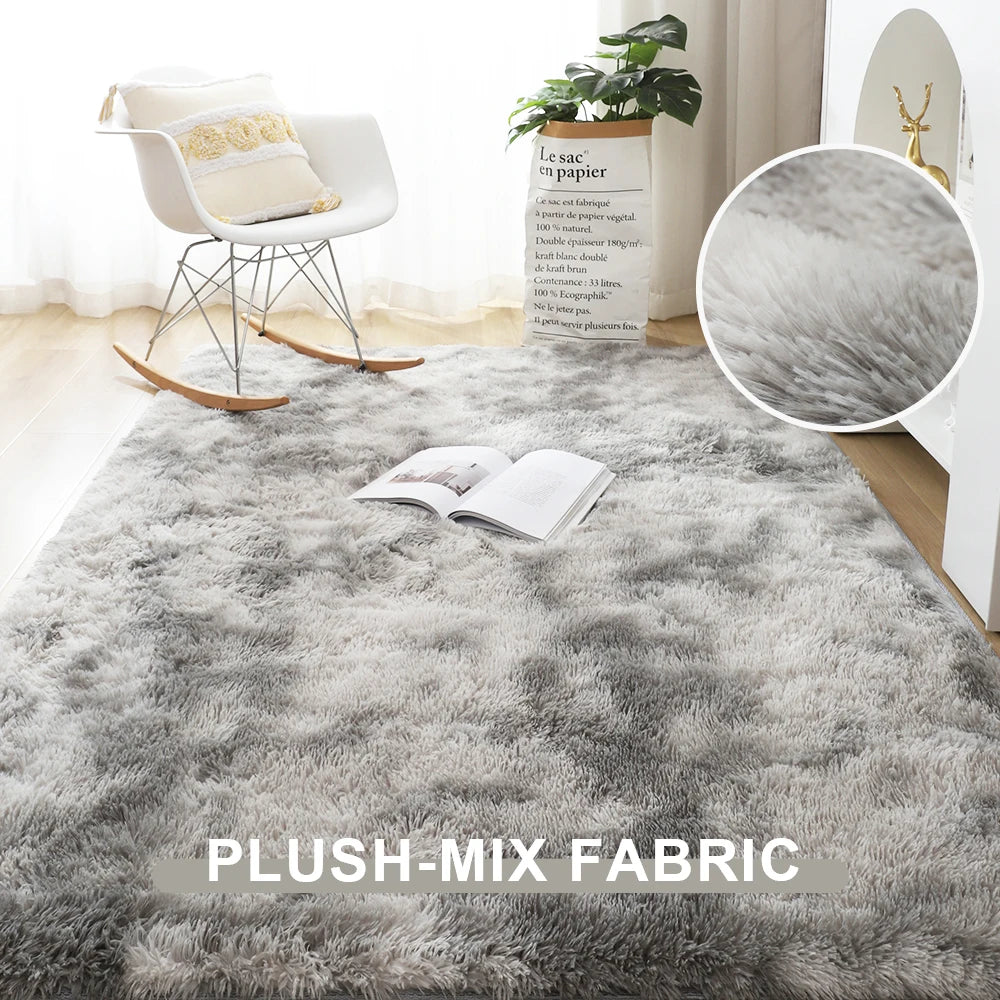 Gray plush-mix rug in a room with a chair and plant, highlighting the plush-mix fabric.