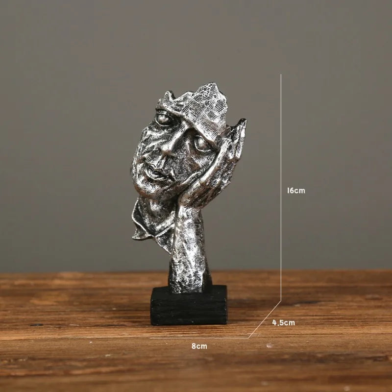 Silver sculpture of a man with its hand supporting its face in a boredom gesture on a gray background, measurements: 8cm x 16cm x 4.5cm 