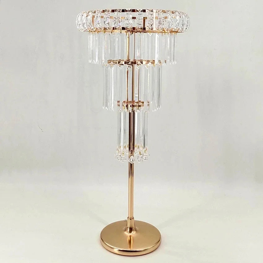 Decorative floor lamp with gold base and crystal accents on a light gray background