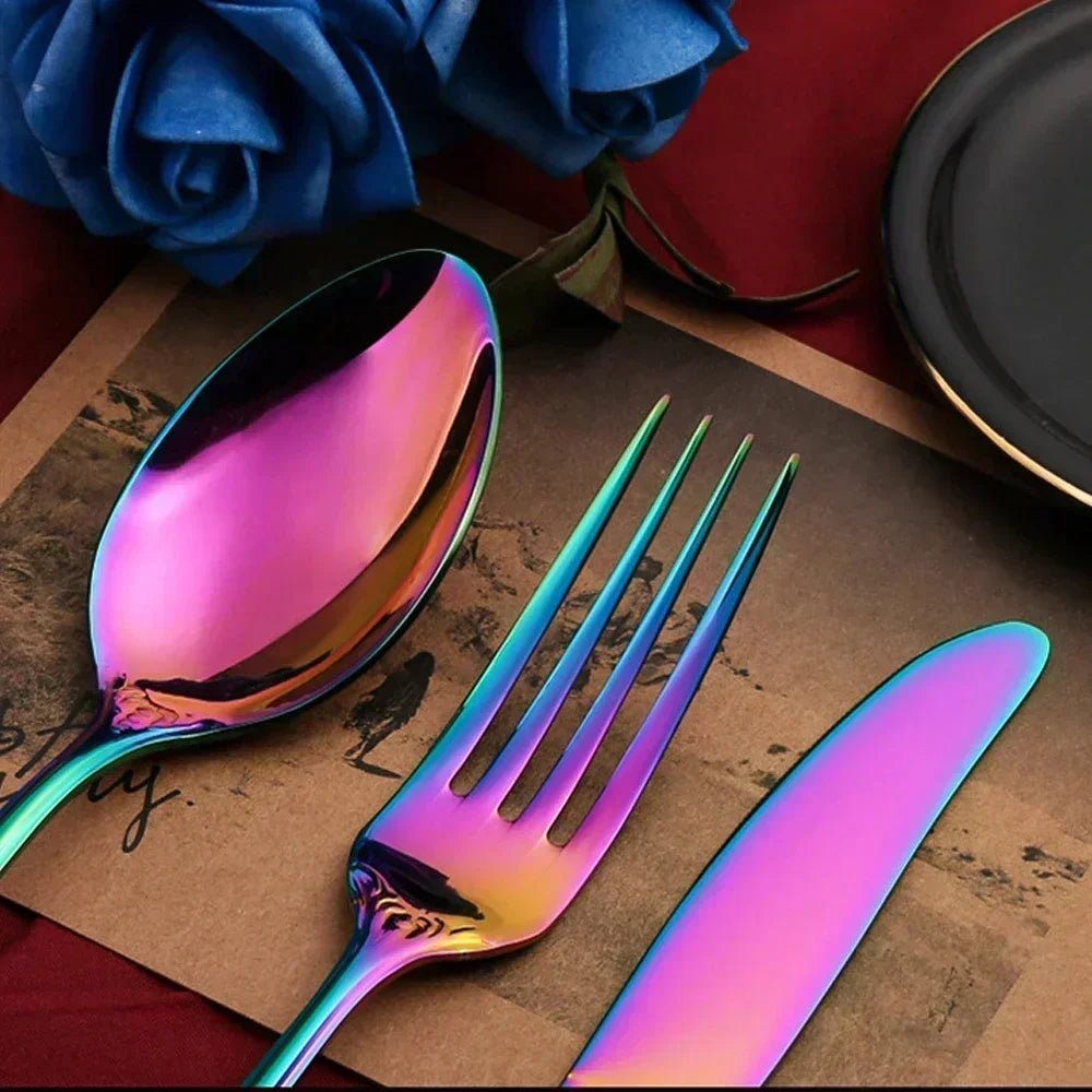 Iridescent cutlery set on a textured surface with blue roses in the background