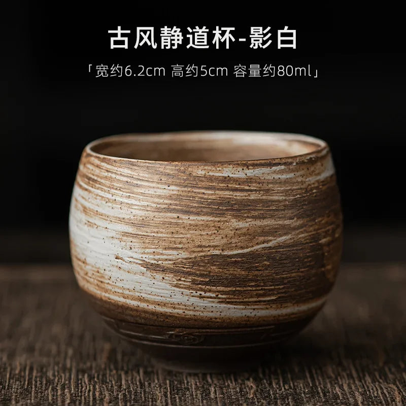 Ceramic cup with brown and white marbled pattern on a dark background