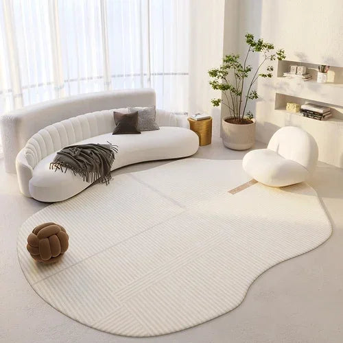 Modern living room with a white sofa, round rug, and decorative items.