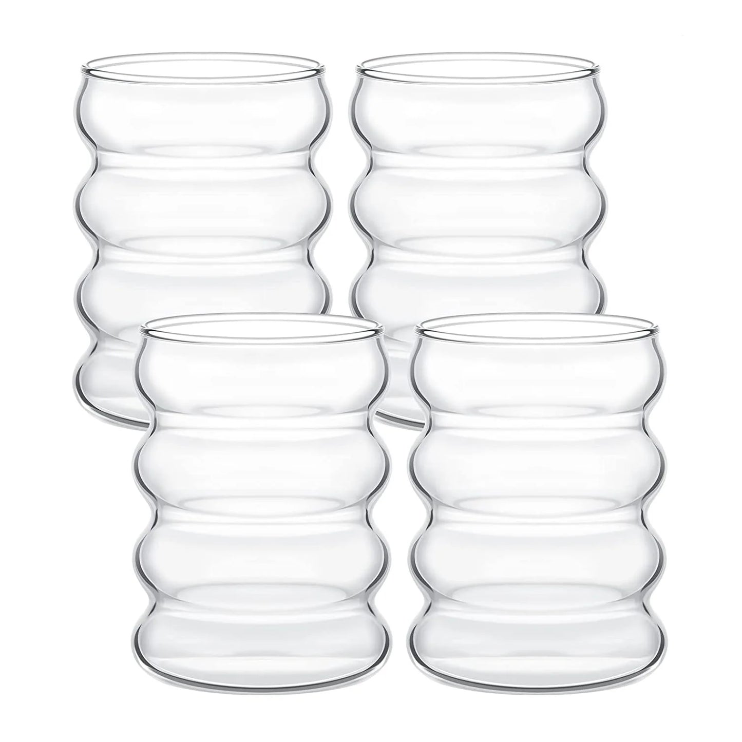 Set of four clear glass tumblers with a wavy design on a white background
