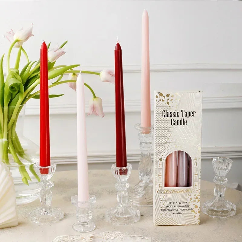 Set of red, pink, and white candles with a box labeled 'Classic Taper Candle' on a decorative surface.