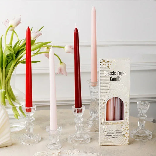 Set of red, pink, and white candles with a box labeled 'Classic Taper Candle' on a decorative surface.