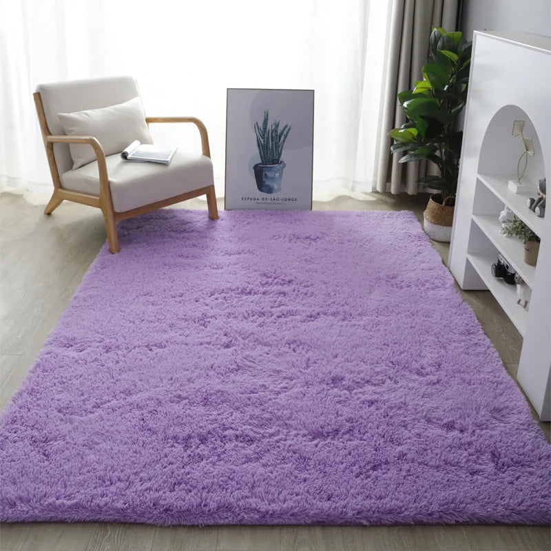 Purple rug in a room with a chair, plant, and white shelf.