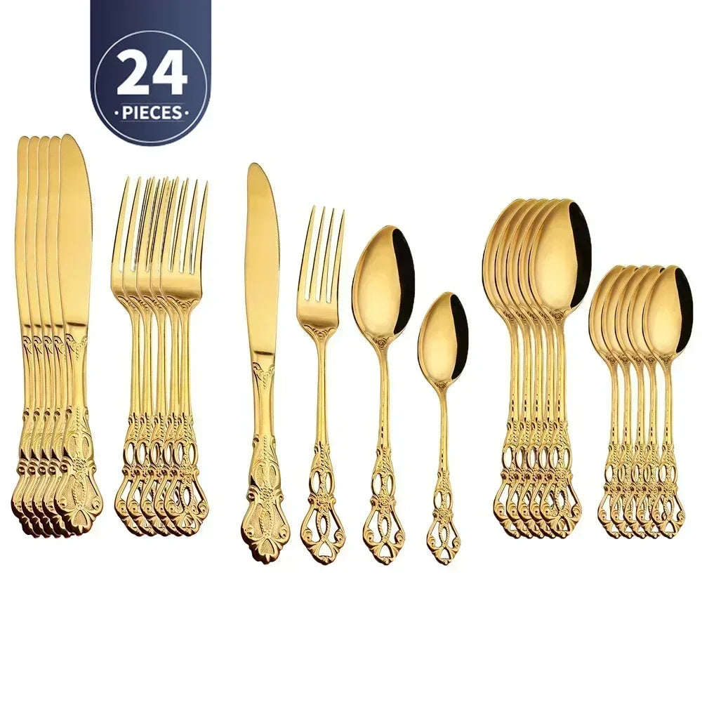 Gold flatware set with 24 pieces on a white background