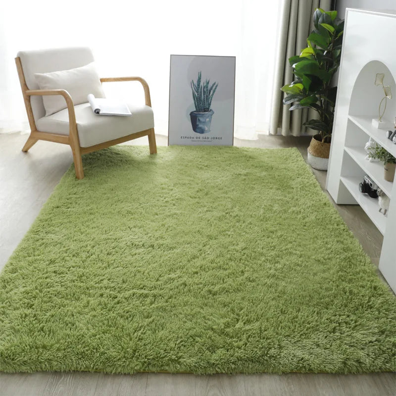 Green rug in a living room with a chair and decor items.