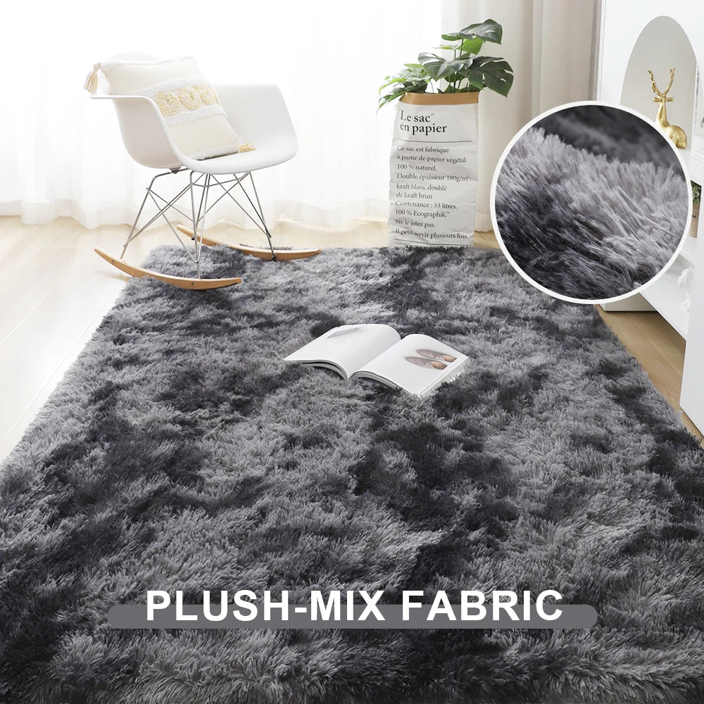 Gray plush-mix rug in a room with a chair and plant, close-up of fabric texture shown.