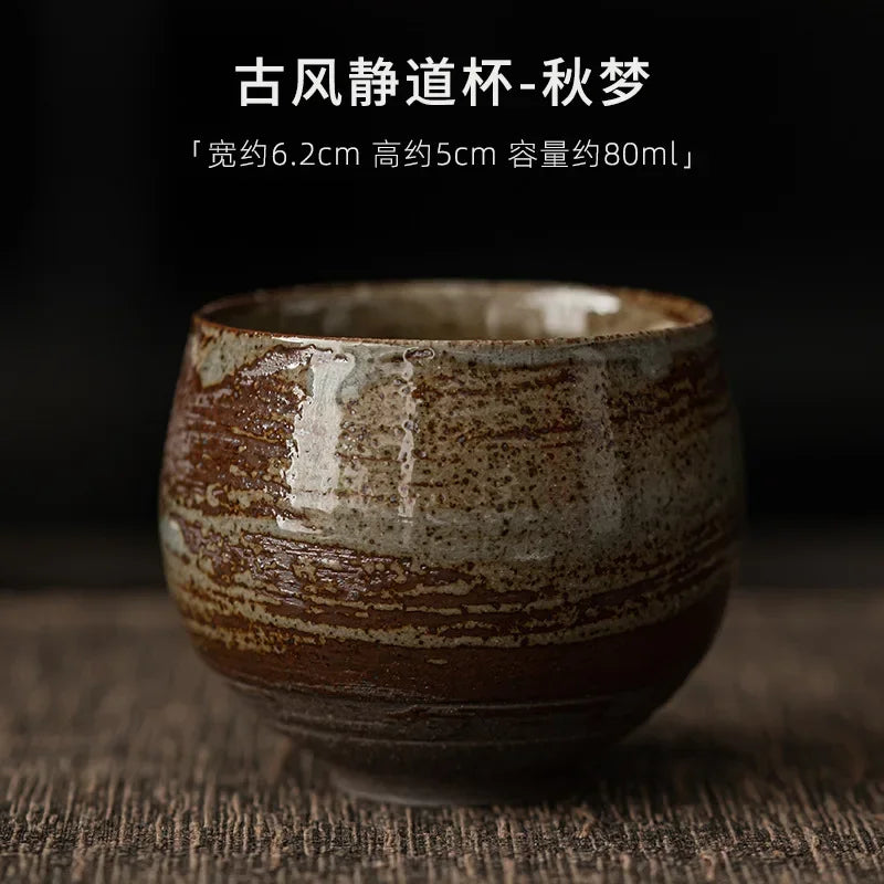 Ceramic cup with brown and beige glaze on a dark background