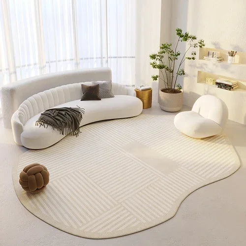 Modern living room with a white rug, curved sofa, and decorative items.