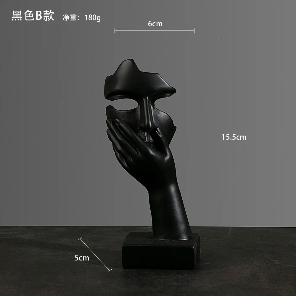 Black sculpture of a hand holding a mask with measurements: 5cm x 15.5cm x 6cm