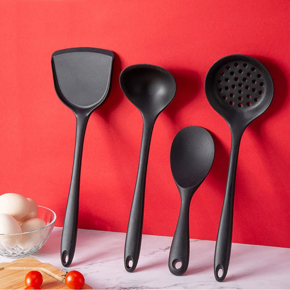 Set of black kitchen utensils on a red background
