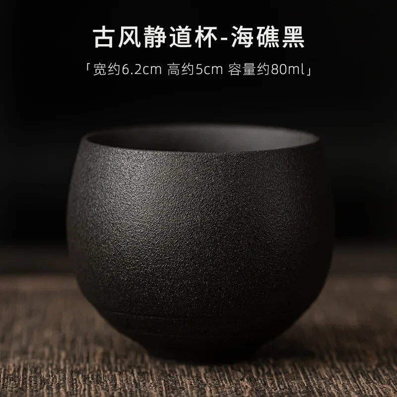 Black ceramic cup on a wooden surface with text overlay