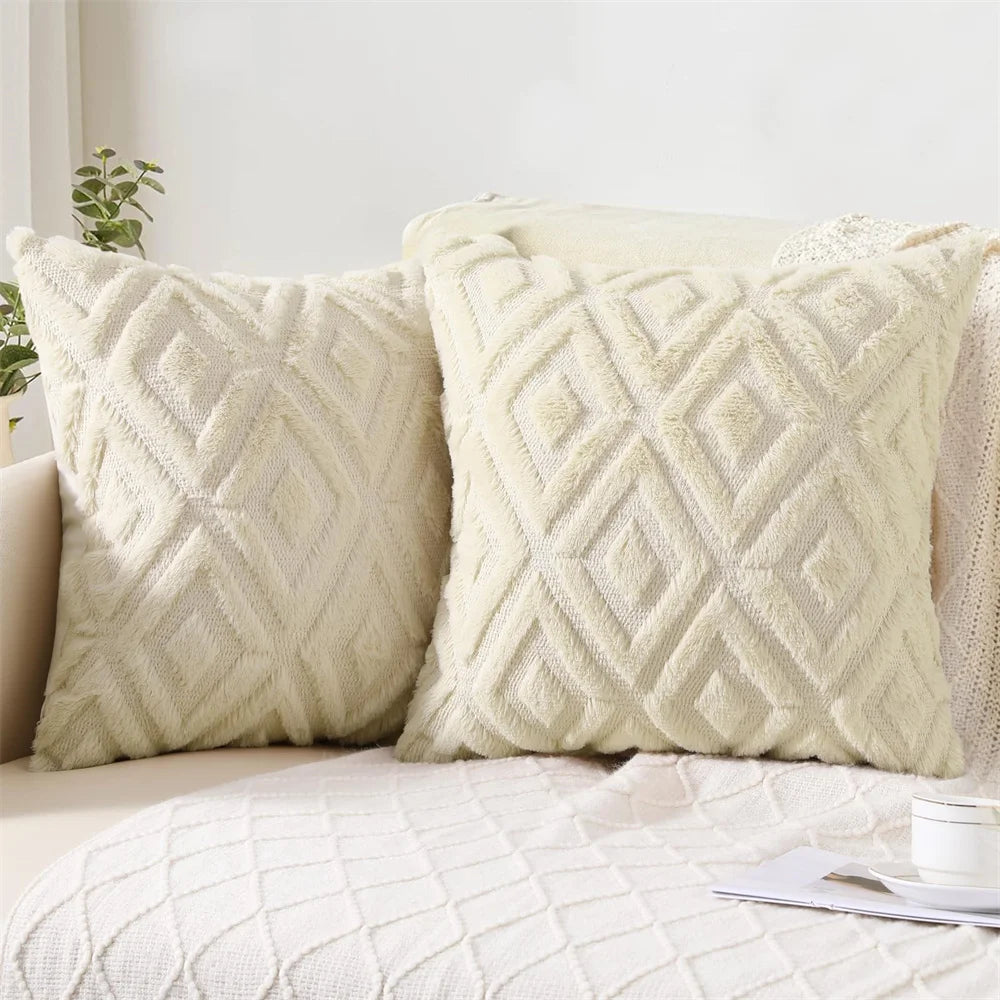 Two textured beige pillows on a sofa with a light background