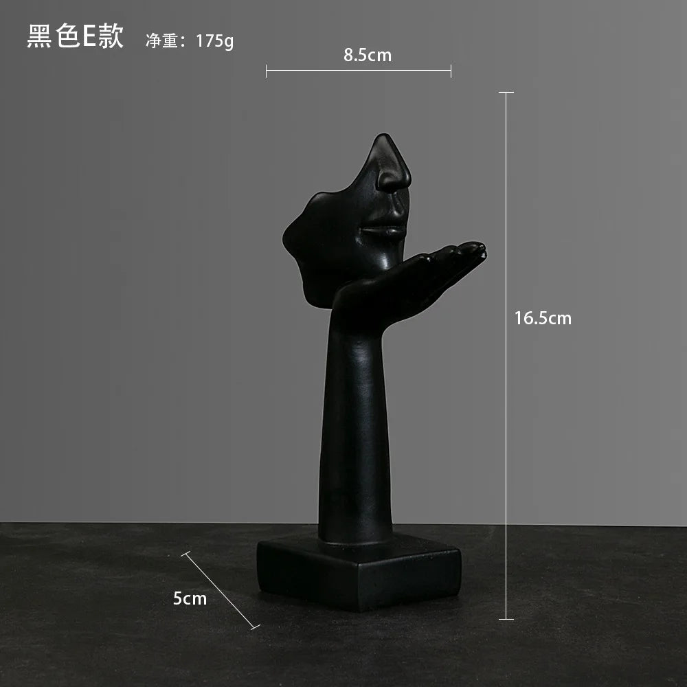 Black abstract sculpture of a palm supporting a chin with dimensions:  5cm x 16.5cm x 8.5cm