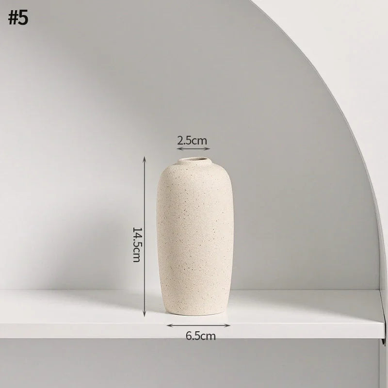 Beige ceramic vase with dimensions: 6.5cm diameter base, 2.5cm diameter hole, 14.5cm height