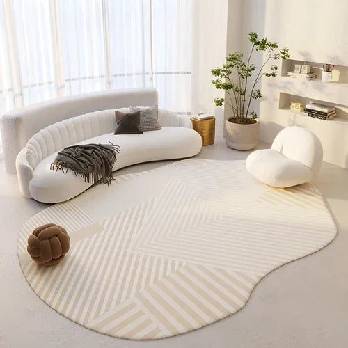 Modern living room with a curved white sofa, round chair, and patterned rug.