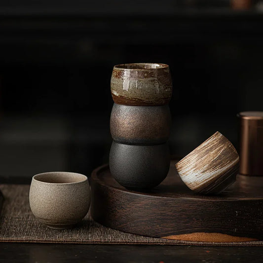 Stacked ceramic bowls on a wooden surface with a dark background