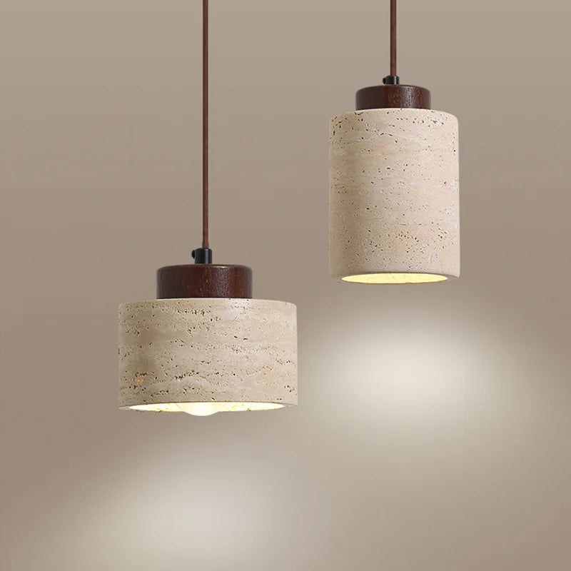 Two pendant lights with beige cylindrical shades and wooden bases on a beige background.