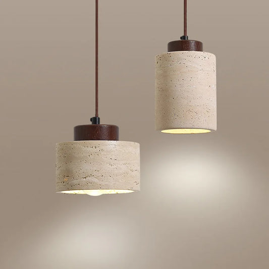 Two pendant lights with beige cylindrical shades and wooden bases on a beige background.
