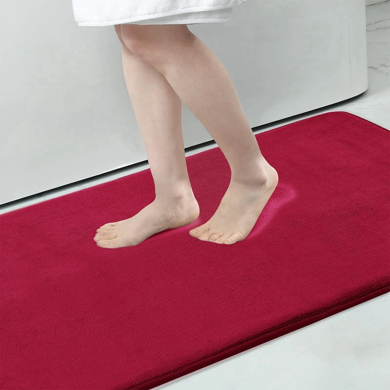 Red bath mat with a person stepping onto it