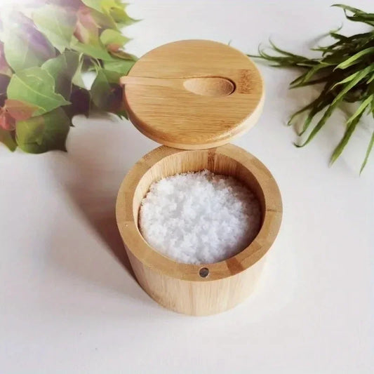 Wooden container with a lid filled with white pearls on a light background